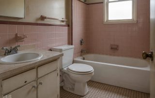 Dated bathroom with worn tile and tired grout