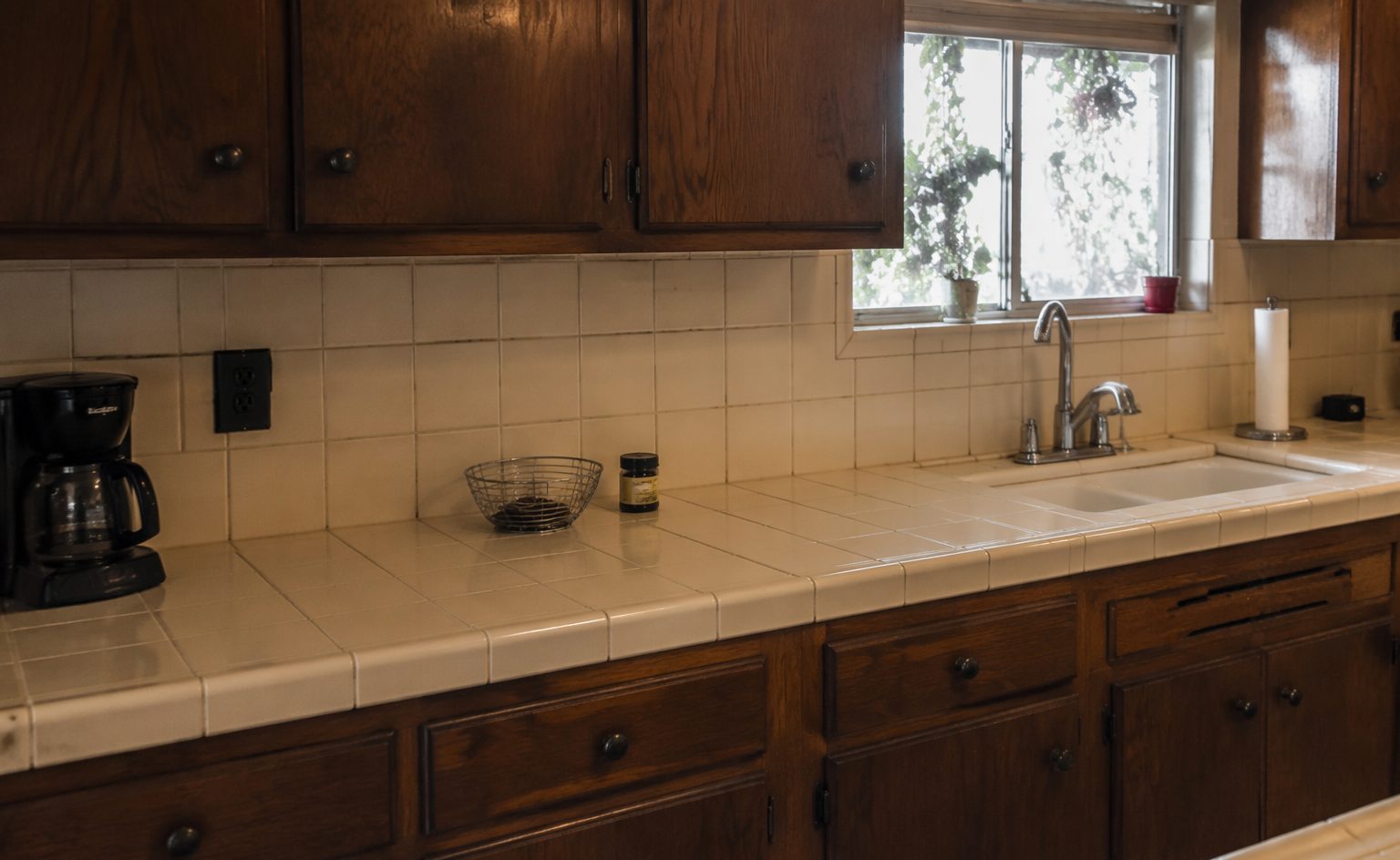 A dated tiled kitchen counter and backsplash before renewal in a Los Angeles kitchen